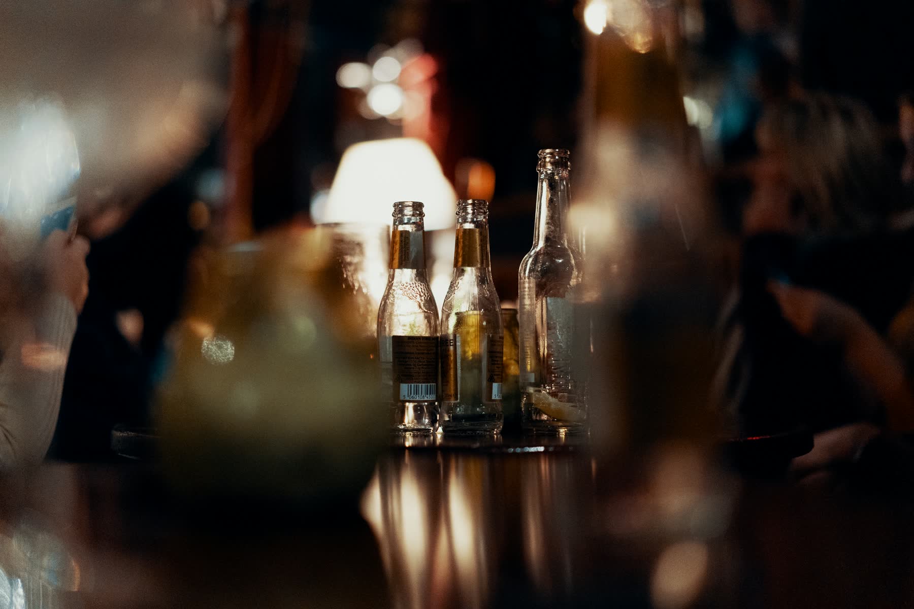 Bottles on a bar counter in warm evening light